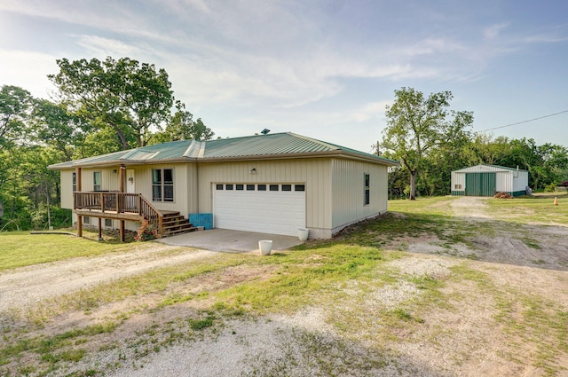 2121 E 505th Rd, Halfway, MO 65663 - single story home featuring driveway, a garage, metal roof, a porch, and a front lawn