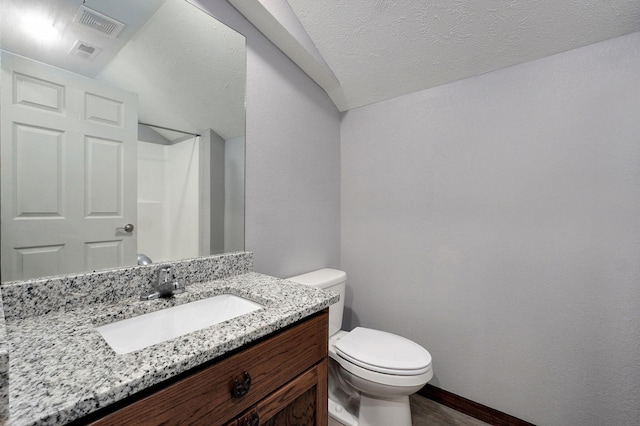 2121 E 505th Rd, Halfway, MO 65663 - bathroom with toilet, vanity, wood finished floors, baseboards, and a textured ceiling