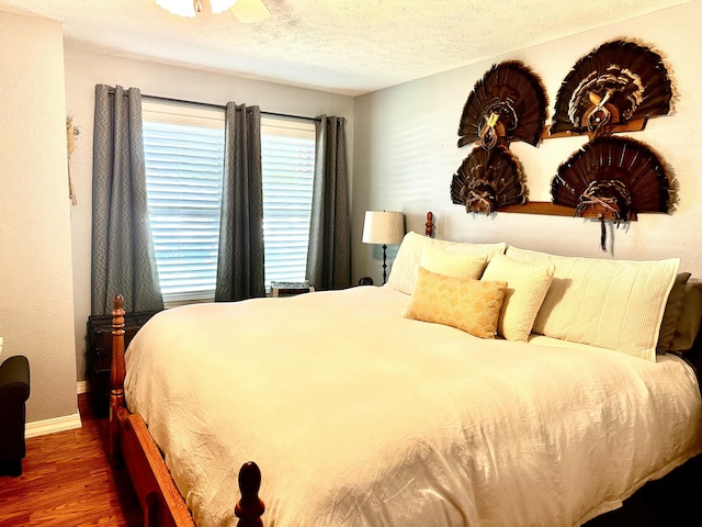 64 Deer Park Cir, Kimberling City, MO 65686 - bedroom featuring wood finished floors, baseboards, a textured ceiling, and ceiling fan
