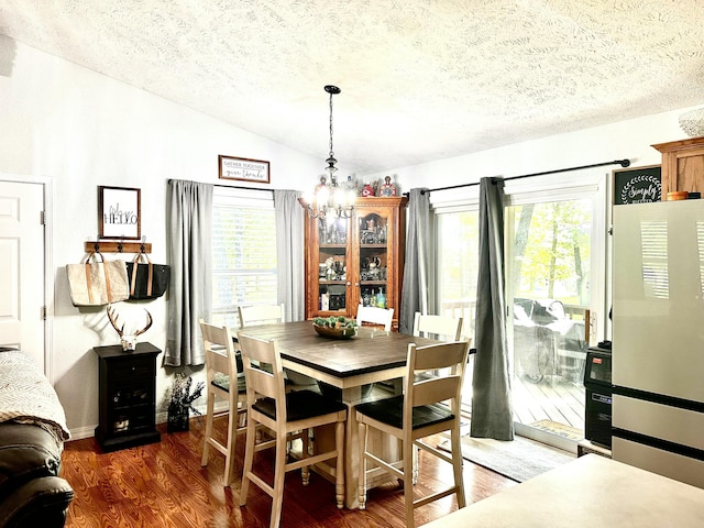 64 Deer Park Cir, Kimberling City, MO 65686 - dining space featuring vaulted ceiling, a textured ceiling, a chandelier, and dark wood finished floors