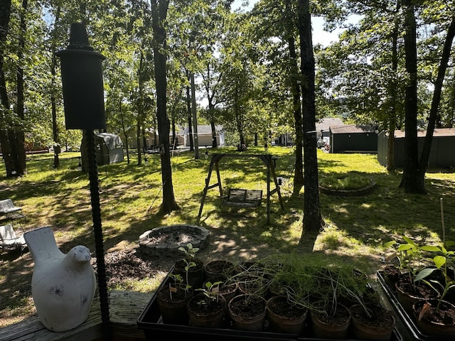 64 Deer Park Cir, Kimberling City, MO 65686 - view of green lawn featuring an outdoor fire pit