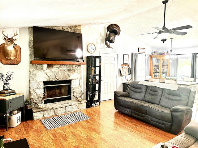 64 Deer Park Cir, Kimberling City, MO 65686 - living area with lofted ceiling, a ceiling fan, wood finished floors, and a stone fireplace