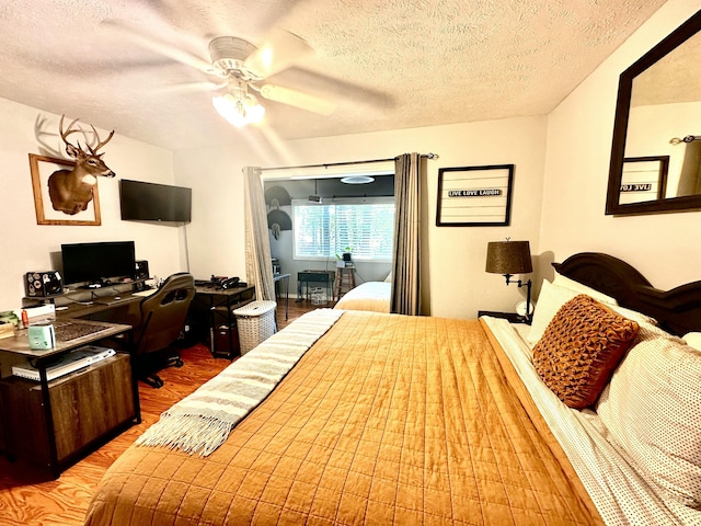 64 Deer Park Cir, Kimberling City, MO 65686 - bedroom with wood finished floors, a textured ceiling, a desk, and ceiling fan