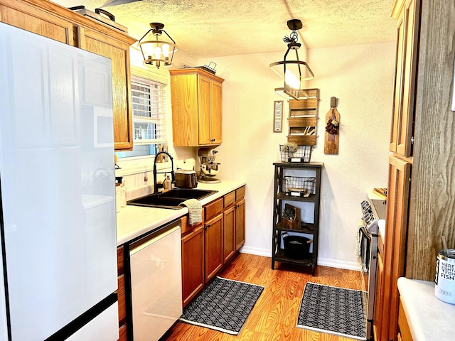 64 Deer Park Cir, Kimberling City, MO 65686 - kitchen featuring white appliances, a sink, light countertops, light wood-type flooring, and a textured ceiling