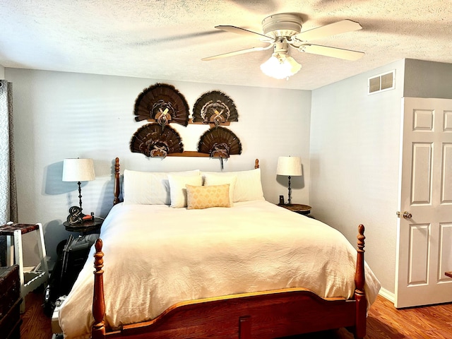 64 Deer Park Cir, Kimberling City, MO 65686 - bedroom with wood finished floors, a textured ceiling, baseboards, and ceiling fan
