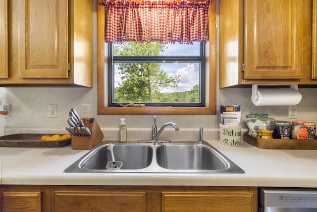 1065 Nicks Rd, Bradleyville, MO 65614 - kitchen with a sink, dishwasher, light countertops, and brown cabinets