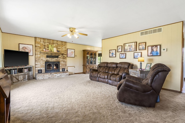 1065 Nicks Rd, Bradleyville, MO 65614 - carpeted living area featuring a ceiling fan, a fireplace, baseboards, and wood walls