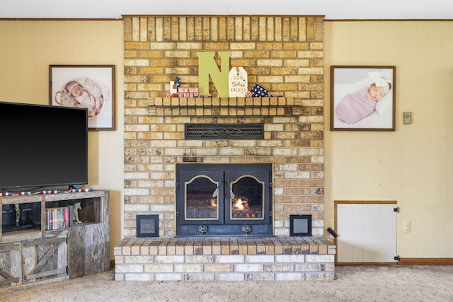 1065 Nicks Rd, Bradleyville, MO 65614 - unfurnished living room with a brick fireplace, carpet, wooden walls, and baseboards