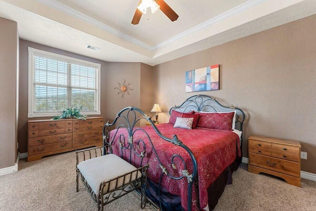 bedroom featuring crown molding, carpet, baseboards, ceiling fan, and a raised ceiling