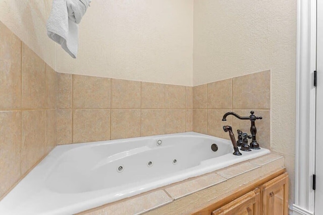 bathroom with a textured wall and a whirlpool tub