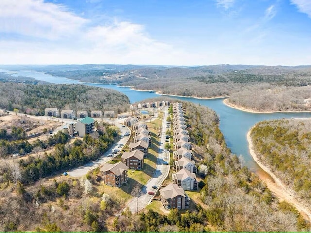 drone / aerial view of a large body of water and a heavily wooded area