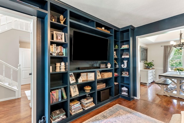 178 S Peach Tree Ln, Republic, MO 65738 - living area with wood finished floors, a chandelier, stairs, and a textured ceiling