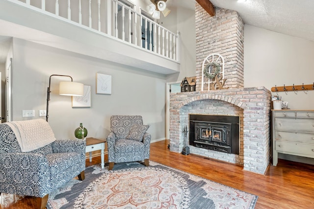 178 S Peach Tree Ln, Republic, MO 65738 - living area featuring high vaulted ceiling, a fireplace, wood finished floors, beamed ceiling, and baseboards