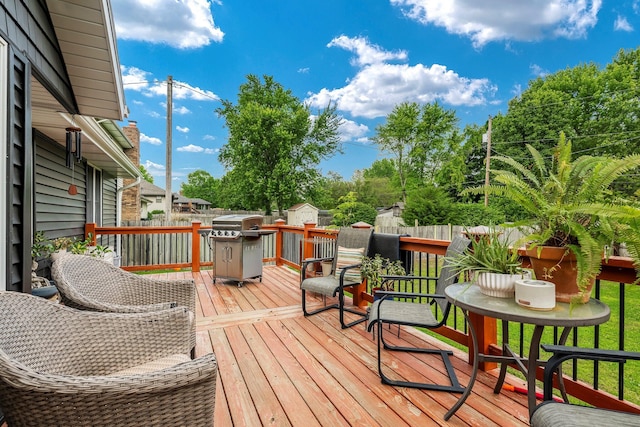 178 S Peach Tree Ln, Republic, MO 65738 - wooden deck featuring a storage shed, a fenced backyard, a grill, and an outbuilding
