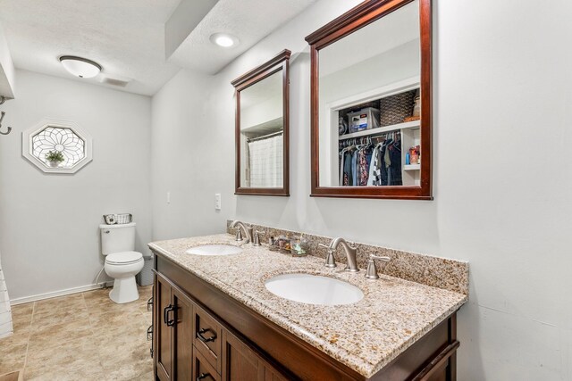 178 S Peach Tree Ln, Republic, MO 65738 - bathroom with toilet, double vanity, and baseboards
