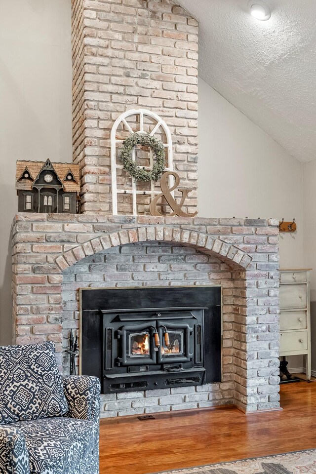 178 S Peach Tree Ln, Republic, MO 65738 - detailed view of wood finished floors, a fireplace, and a textured ceiling