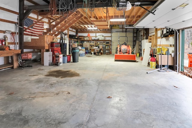 1052 Broken Arrow Estates Rd, Lampe, MO 65681 - garage with a workshop area and a garage door opener