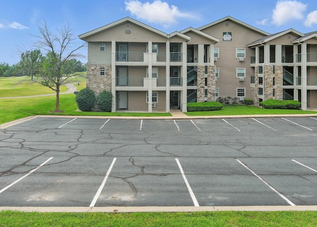 view of building exterior featuring uncovered parking