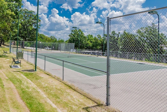 view of tennis court with fence