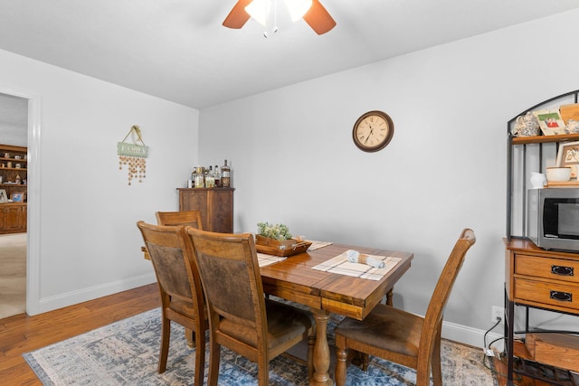 77 Johnson Way Ln, Kimberling City, MO 65686 - dining area with a ceiling fan, light wood-style floors, and baseboards