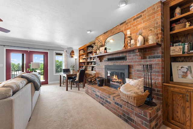77 Johnson Way Ln, Kimberling City, MO 65686 - living room with a brick fireplace, carpet, a textured ceiling, a ceiling fan, and baseboards