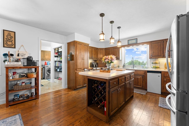77 Johnson Way Ln, Kimberling City, MO 65686 - kitchen with freestanding refrigerator, white dishwasher, washer / clothes dryer, a sink, and light countertops