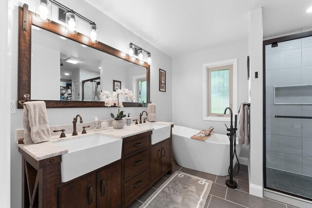 77 Johnson Way Ln, Kimberling City, MO 65686 - bathroom with a stall shower, double vanity, a soaking tub, and baseboards