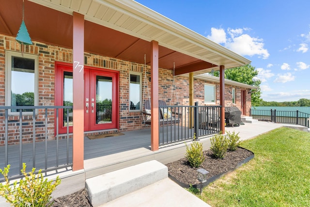 77 Johnson Way Ln, Kimberling City, MO 65686 - entrance to property with covered porch, brick siding, and fence