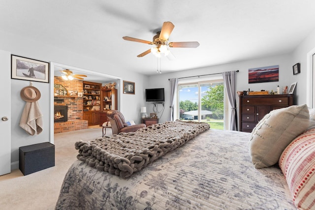 77 Johnson Way Ln, Kimberling City, MO 65686 - carpeted bedroom with access to outside, a brick fireplace, and a ceiling fan