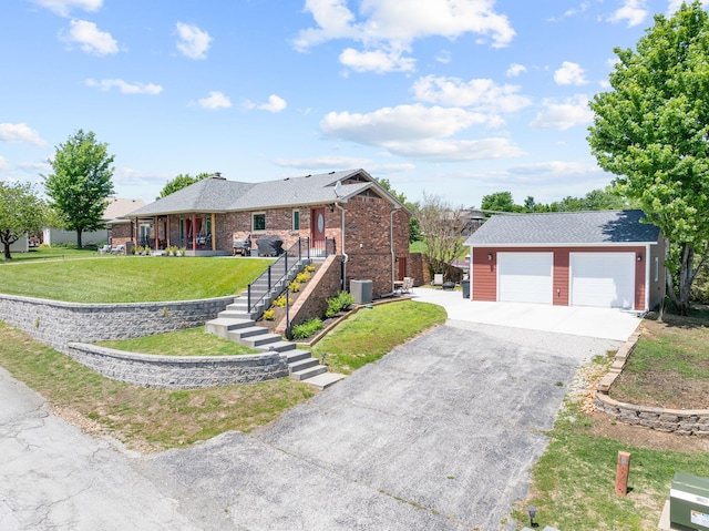 77 Johnson Way Ln, Kimberling City, MO 65686 - single story home with central AC, an outbuilding, a detached garage, a front lawn, and brick siding