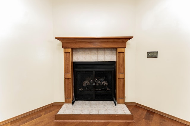 1240 Tyler Ln, Nixa, MO 65714 - detailed view of wood finished floors, baseboards, and a fireplace