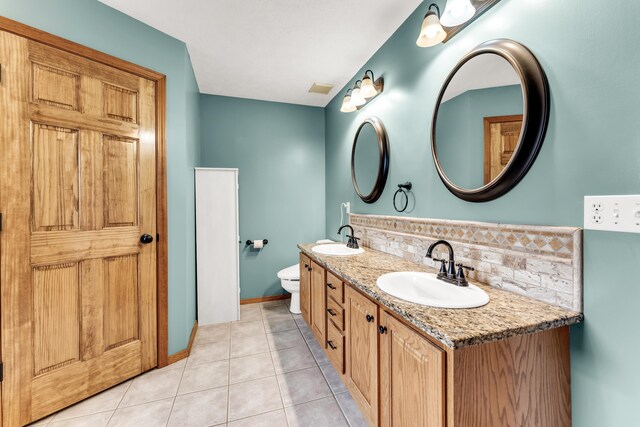 1240 Tyler Ln, Nixa, MO 65714 - full bathroom with tasteful backsplash, tile patterned floors, toilet, double vanity, and baseboards