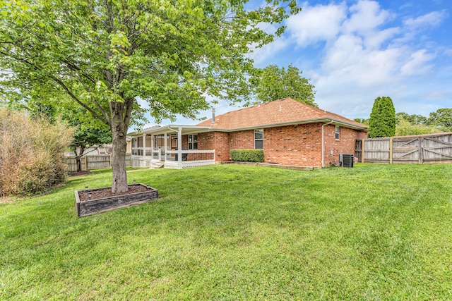 1240 Tyler Ln, Nixa, MO 65714 - back of house featuring a sunroom, brick siding, cooling unit, and a gate