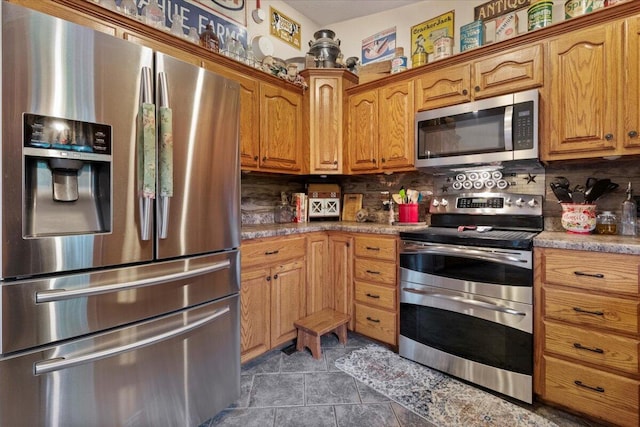 6203 County Road 1750, West Plains, MO 65775 - kitchen featuring stainless steel appliances, decorative backsplash, brown cabinets, tile patterned flooring, and light countertops