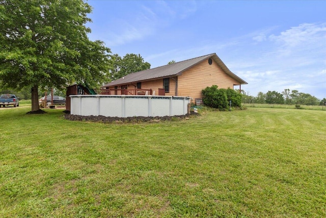 6203 County Road 1750, West Plains, MO 65775 - view of side of property featuring a lawn, an outdoor pool, and metal roof