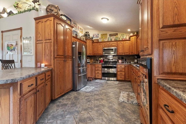 6203 County Road 1750, West Plains, MO 65775 - kitchen featuring stainless steel appliances, brown cabinets, decorative backsplash, lofted ceiling, and stone finish flooring