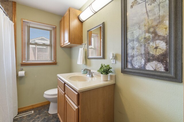 bathroom featuring toilet, vanity, baseboards, and a shower with shower curtain