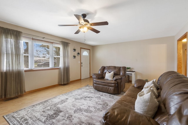 living room with ceiling fan, wood finished floors, and baseboards
