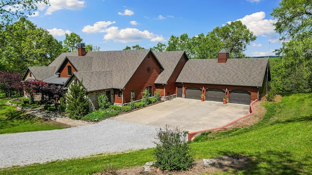 315 Buckskin Rdg, Pineville, MO 64856 - view of front of house featuring a chimney, concrete driveway, roof with shingles, and a front lawn