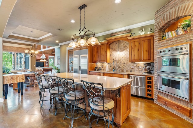 315 Buckskin Rdg, Pineville, MO 64856 - kitchen with stainless steel appliances, a chandelier, a kitchen island, ornamental molding, and a sink