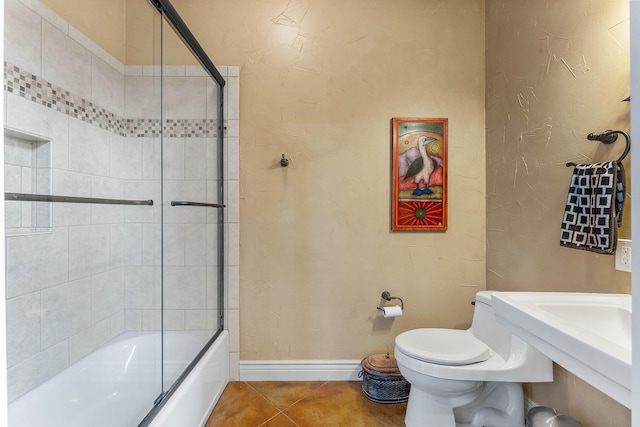 315 Buckskin Rdg, Pineville, MO 64856 - full bath with tile patterned flooring, bath / shower combo with glass door, toilet, and baseboards