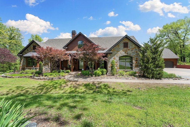 315 Buckskin Rdg, Pineville, MO 64856 - view of front facade with stone siding, a chimney, a front yard, and a garage