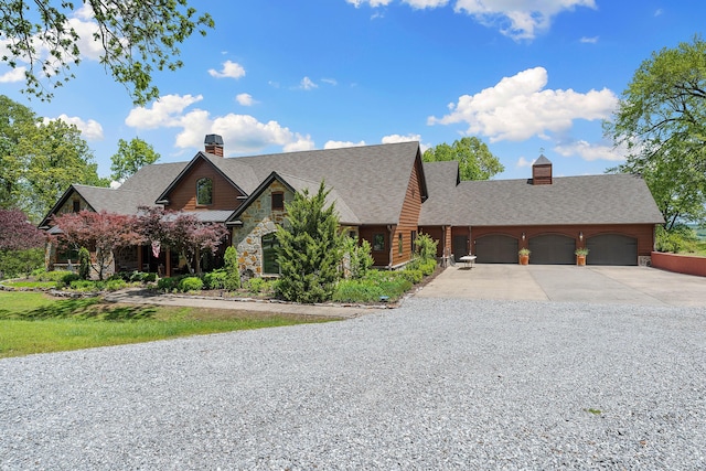 315 Buckskin Rdg, Pineville, MO 64856 - view of front facade with driveway, a chimney, stone siding, a garage, and roof with shingles