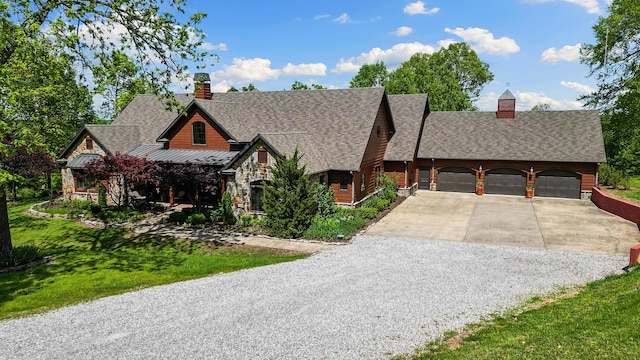 315 Buckskin Rdg, Pineville, MO 64856 - view of front of home with concrete driveway, a chimney, a standing seam roof, and a shingled roof