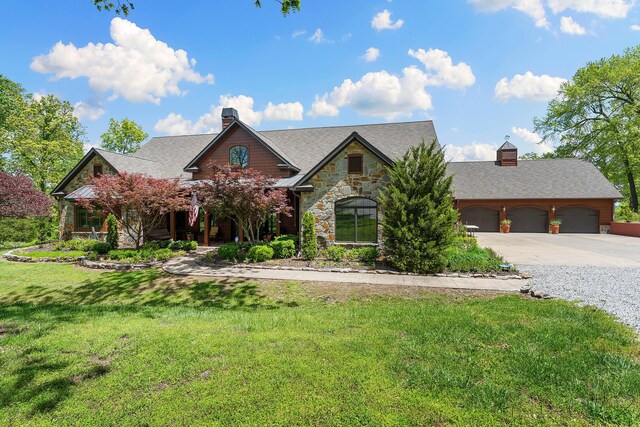 315 Buckskin Rdg, Pineville, MO 64856 - view of front of house featuring a chimney, concrete driveway, stone siding, a front lawn, and roof with shingles