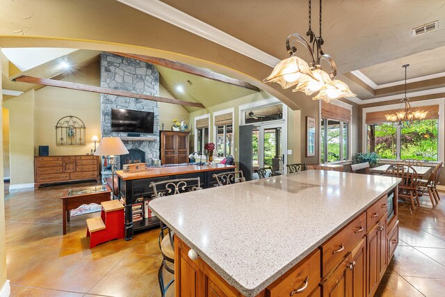 315 Buckskin Rdg, Pineville, MO 64856 - kitchen featuring a chandelier, open floor plan, light stone countertops, light tile patterned flooring, and a kitchen island