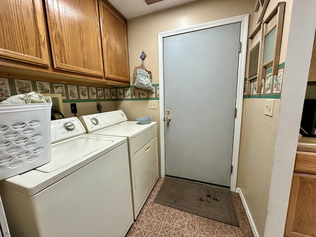 washroom featuring cabinet space and washing machine and dryer