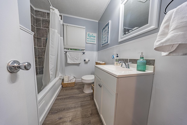 bathroom with ornamental molding, toilet, vanity, wood finished floors, and shower / bathtub combination with curtain