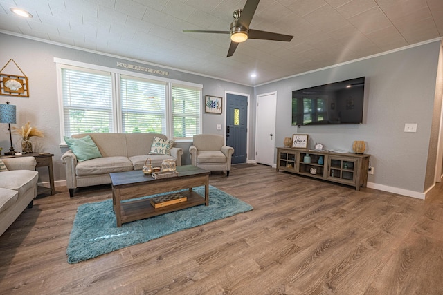 living room with ornamental molding, ceiling fan, wood finished floors, baseboards, and recessed lighting