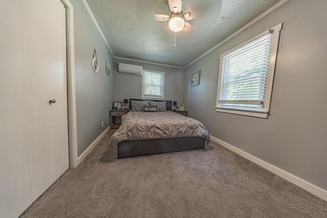 bedroom with ornamental molding, a textured ceiling, a wall mounted AC, carpet flooring, and a ceiling fan